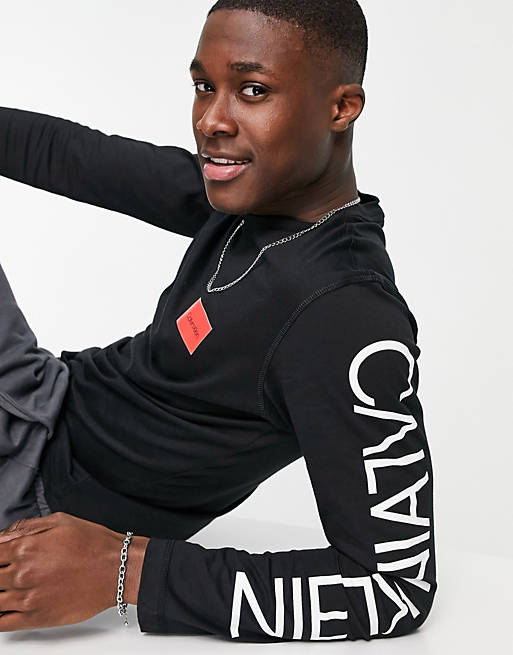 Calvin Klein reversed logo arm long sleeve top in black | ASOS