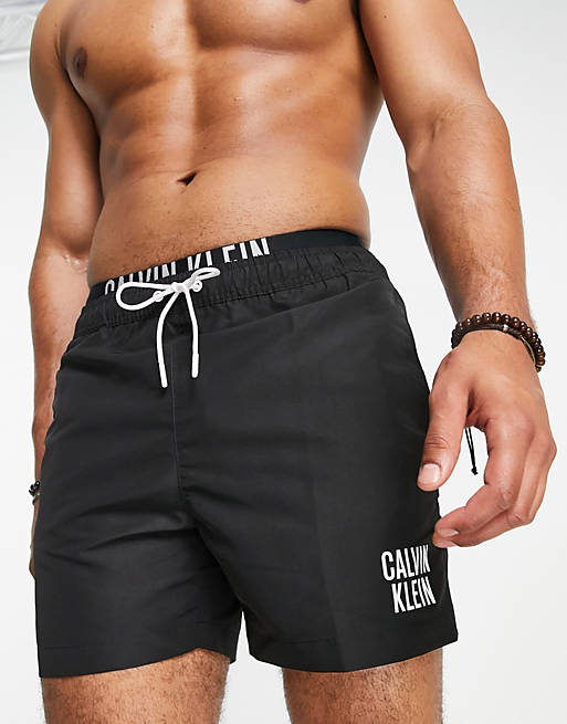 Calvin Klein small thigh logo swim shorts in black | ASOS