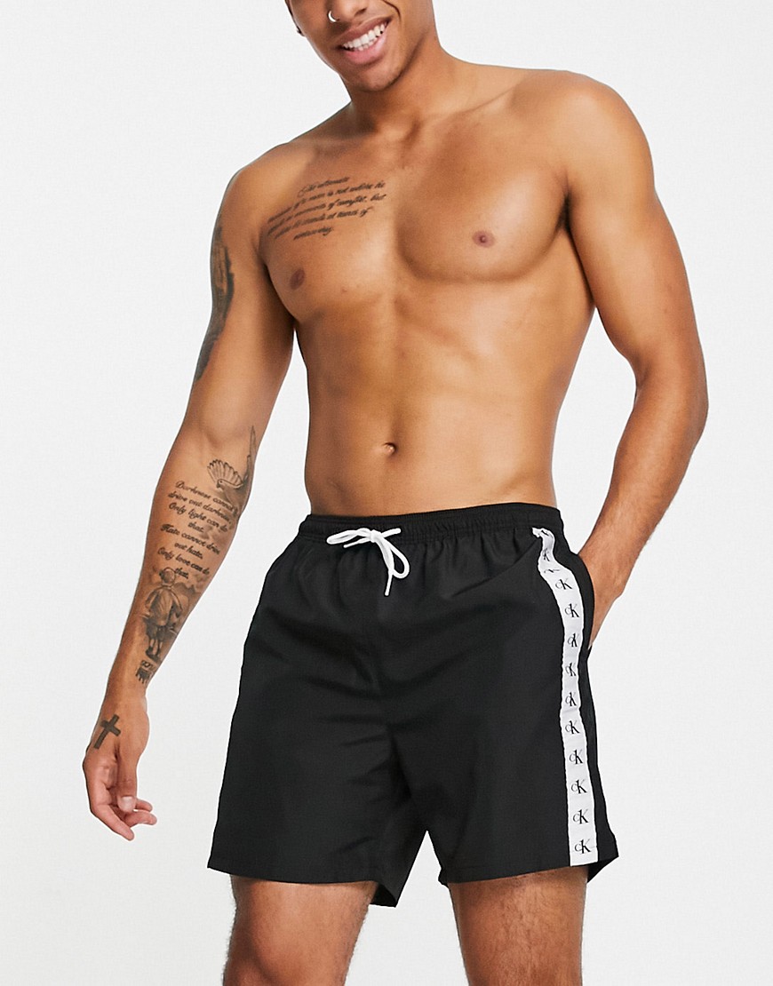 Calvin Klein swim shorts with logo side taping in black