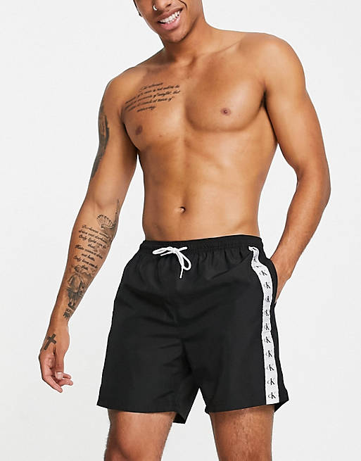 Calvin Klein swim shorts with logo side taping in black