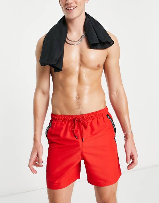 Calvin Klein swim trunks in red with taping | ASOS