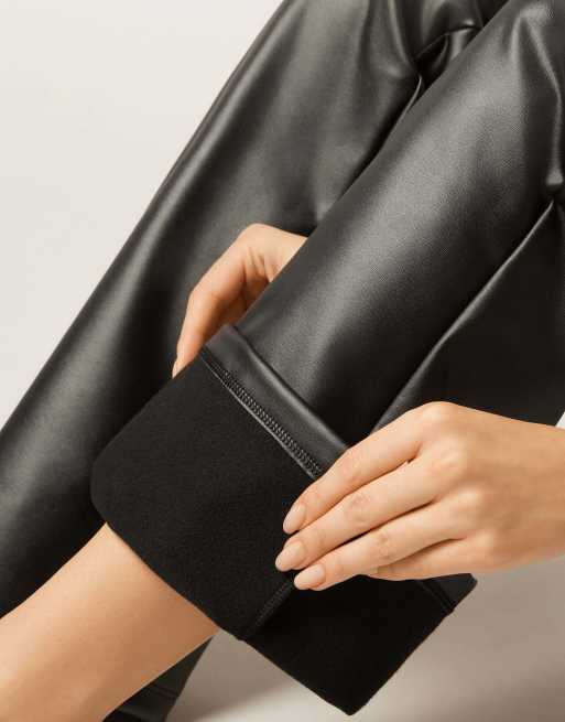Calzedonia Coated-effect thermal flared trousers in black, 3 of 5