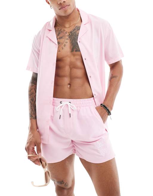 Camisa playera rosa con bordado de flor de hibisco de Another Influence