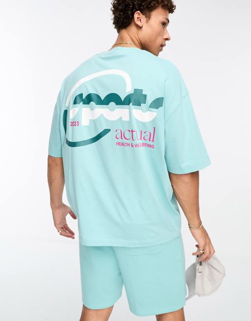 Camiseta azul extragrande con estampados deportivos del logo de ASOS Actual (parte de un conjunto)