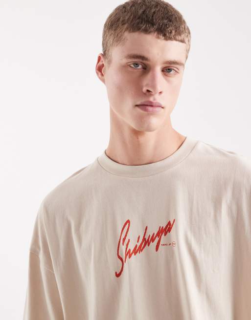 Camiseta beis extragrande con gráfico de texto de ASOS DESIGN, 3 de 5