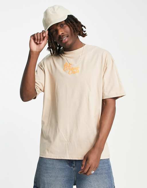 Camiseta beis holgada con estampado neón del logo de The Couture Club