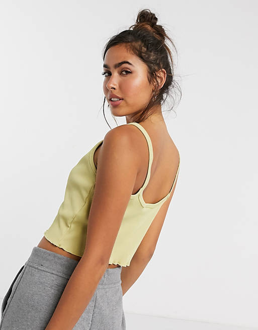 Mujer Tops | Camiseta corta sin mangas de canalé en color aceite con bajo ondulado de Nike - RH25297