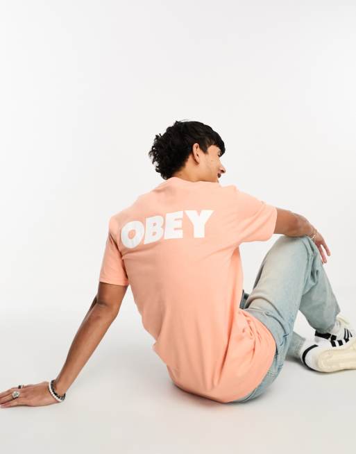 Camiseta naranja con estampado de logo llamativo en la espalda de Obey