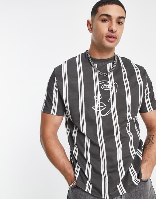 Camiseta negra holgada a rayas verticales con bordado delineado de rostro de ASOS DESIGN 