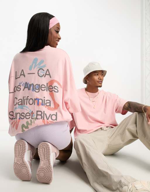 Camiseta unisex extragrande con lavado rosa y estampado gráfico trasero de ASOS DESIGN , 3 de 4