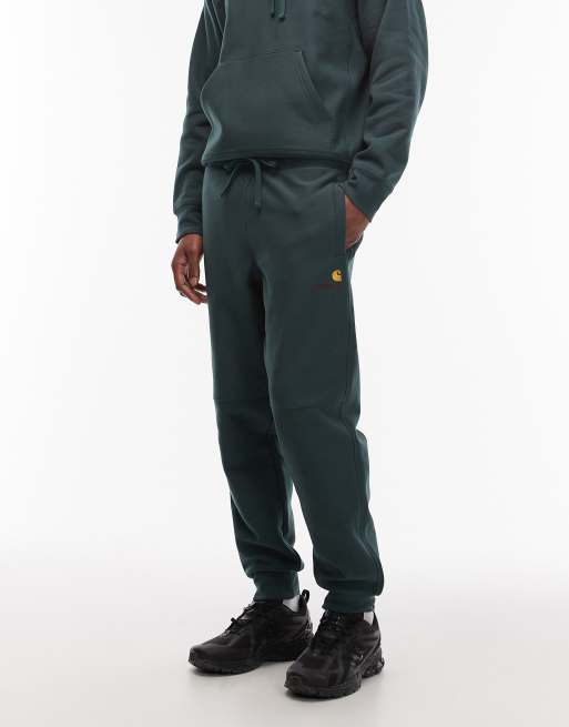Carhartt WIP amercian script joggers in dark green