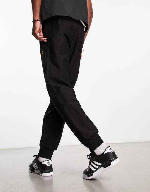 Carhartt WIP american script trackies in black, 2 of 4