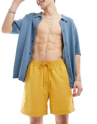 Carhartt WIP chase swim shorts in yellow