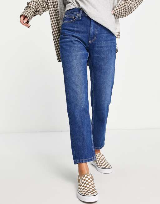 Carhartt WIP – Ciemnoniebieskie dopasowane jeansy z efektem sprania