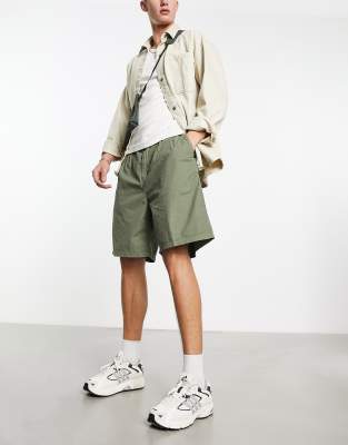 Carhartt WIP colston loose fit chino shorts in green - ASOS Price Checker