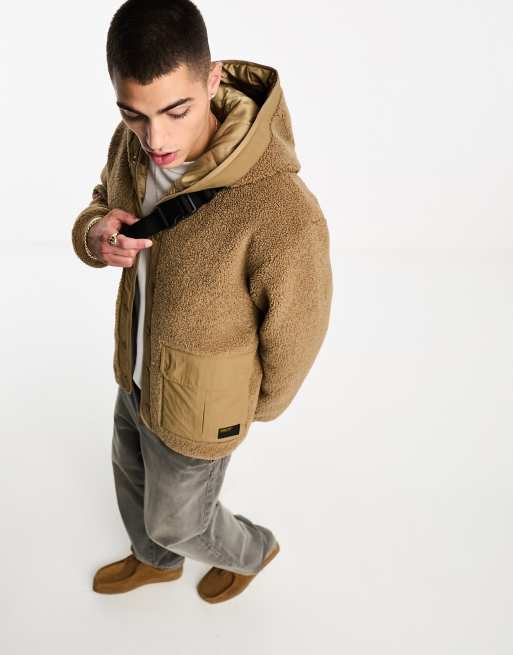 Carhartt WIP – Devin – Brązowa kurtka z kapturem ze sztucznego kożuszka