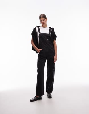 Carhartt WIP - Jeanslatzhose in verwaschenem Schwarz