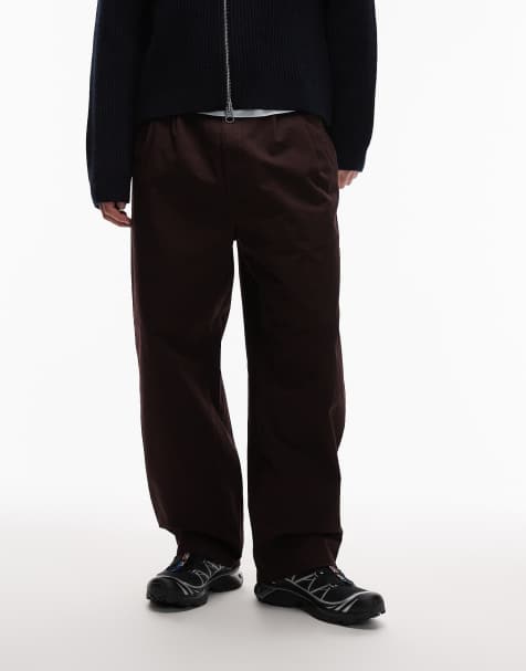 Carhartt WIP – Merrick – Schmal zulaufende Hose in Dunkelbraun mit lockerem Schnitt - view 1