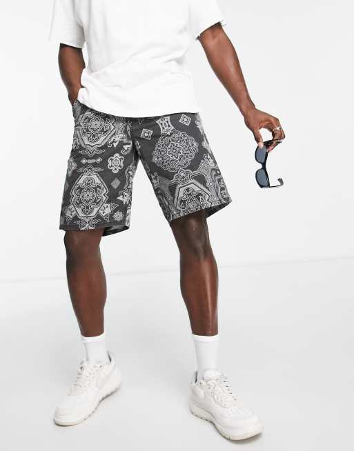 Carhartt WIP – Single Knee – Shorts in Schwarz mit Paisleymuster