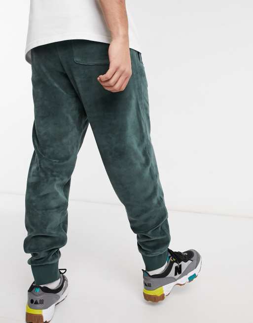 Carhartt WIP united script velour joggers in green