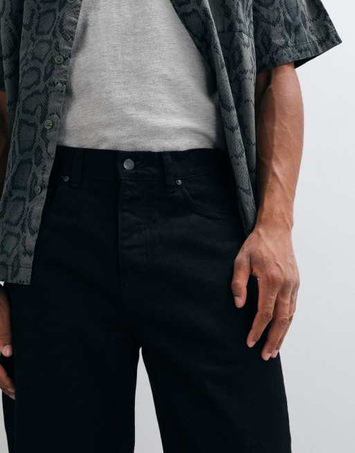 Carhartt WIP - Vaqueros Newel de corte relajado y tapered en lavado negro, 3 de 5