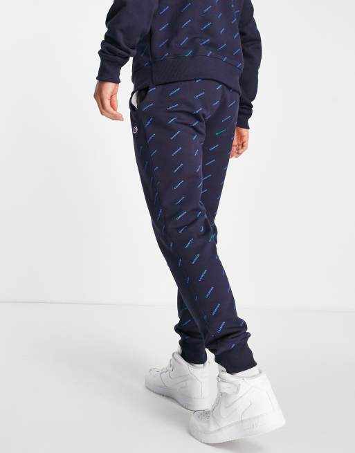 Champion all over logo print sweatpants in navy ASOS