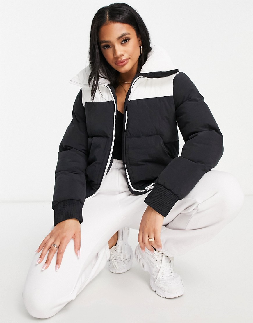 Champion large logo cropped puffer jacket in black and white