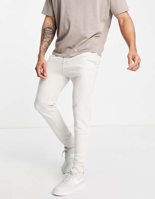 Champion large logo joggers in tan ASOS