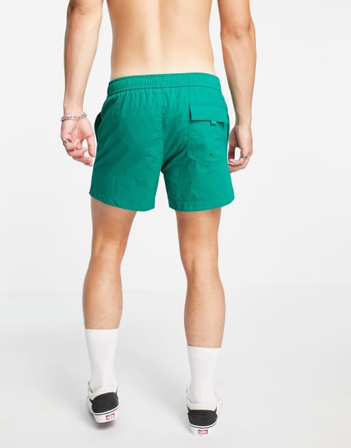 Champion small logo beach shorts in green | ASOS