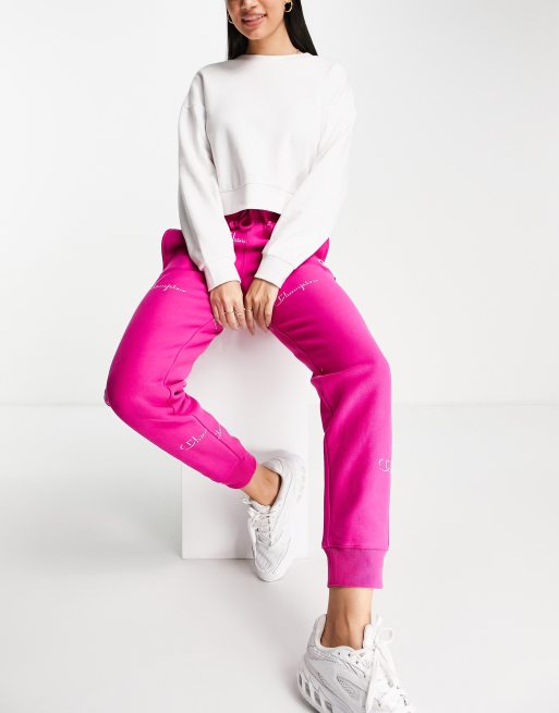 Champion sweatpants with repeat logo in pink ASOS