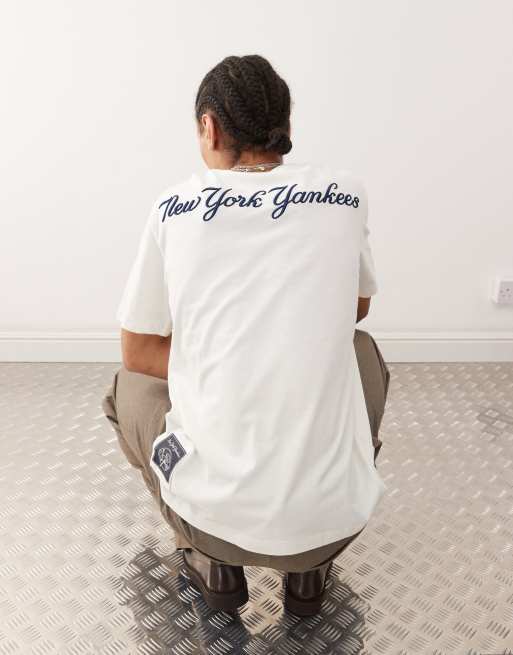 Champion - T-shirt manches courtes avec imprimé NY au dos - Blanc cassé  