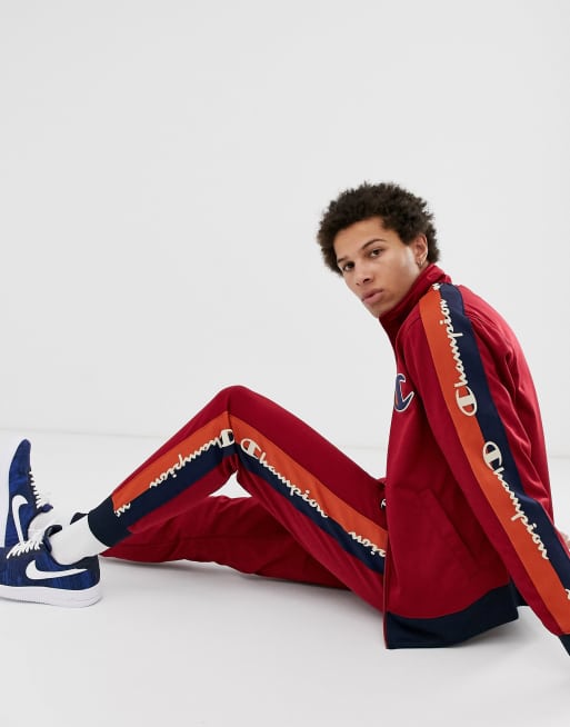 Champion Tricot track pants with taping in red ASOS