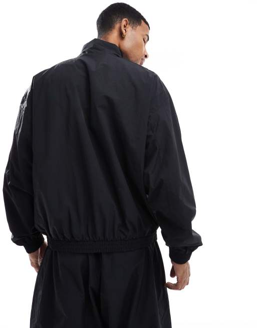 Chaqueta de chándal negra extragrande de tejido liso de Nike Club