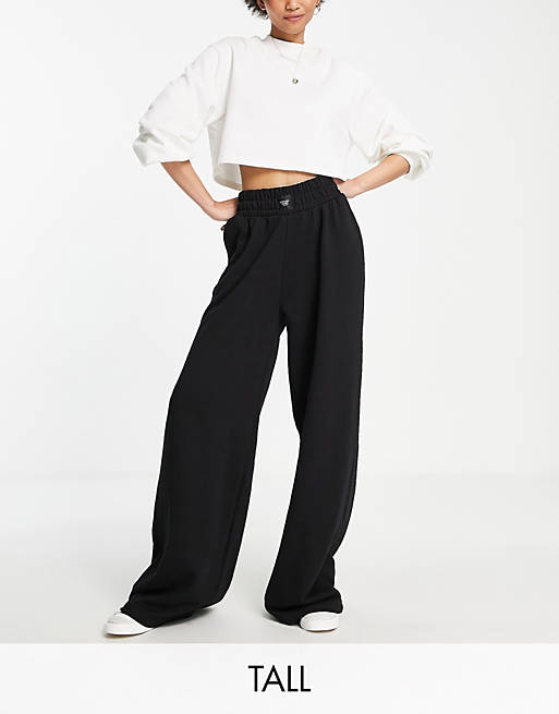 Chelsea Peers Tall high rise wide leg sweatpants with woven logo tab in black