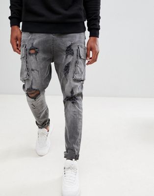 фото Черные джинсы заниженного кроя с карманами-карго и рваной отделкой asos design-черный