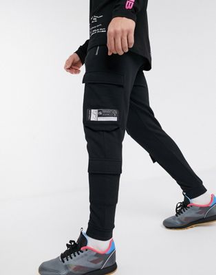 фото Черные трикотажные брюки карго с молниями the couture club-черный