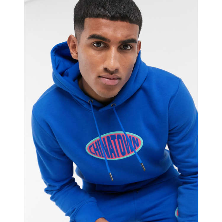 Chinatown Market Oval chest logo hoodie in blue | ASOS