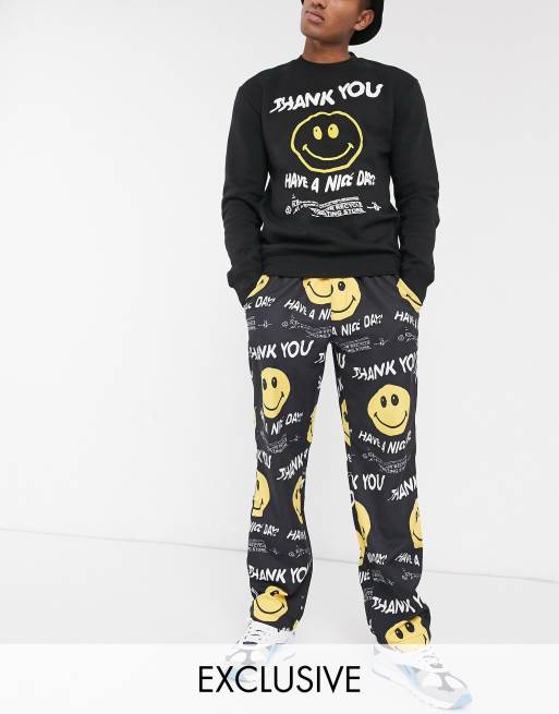 Chinatown Market Smiley Twisted Have A Nice Day lightweight woven pants in  black