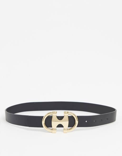 Cinturón para vaqueros en negro con diseño para la cadera y la cintura y bridón circular doble en dorado de ASOS DESIGN