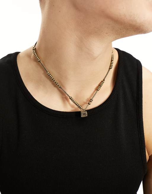 Classics 77 - Collana color oro con perline e pendente con motivo