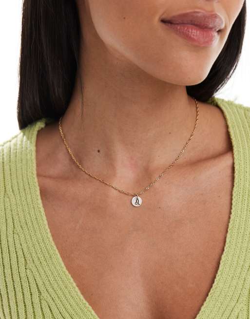 Collar chapado en oro de 14 quilates con disco de nácar sintético, colgante de signo del zodiaco Leo y bolsa de regalo de ASOS DESIGN