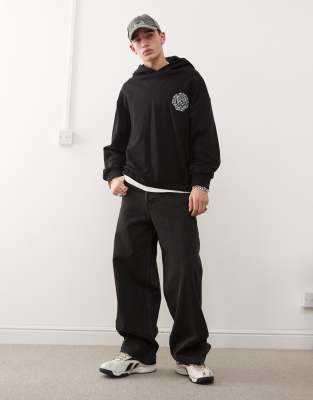 Black boxy cropped hoodie in black with logo emblem