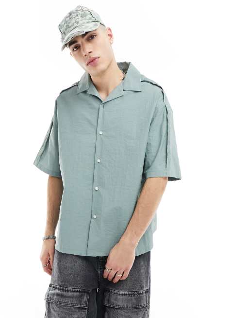 COLLUSION - Camicia tecnica a maniche corte blu con cuciture grezze sui bordi e rever