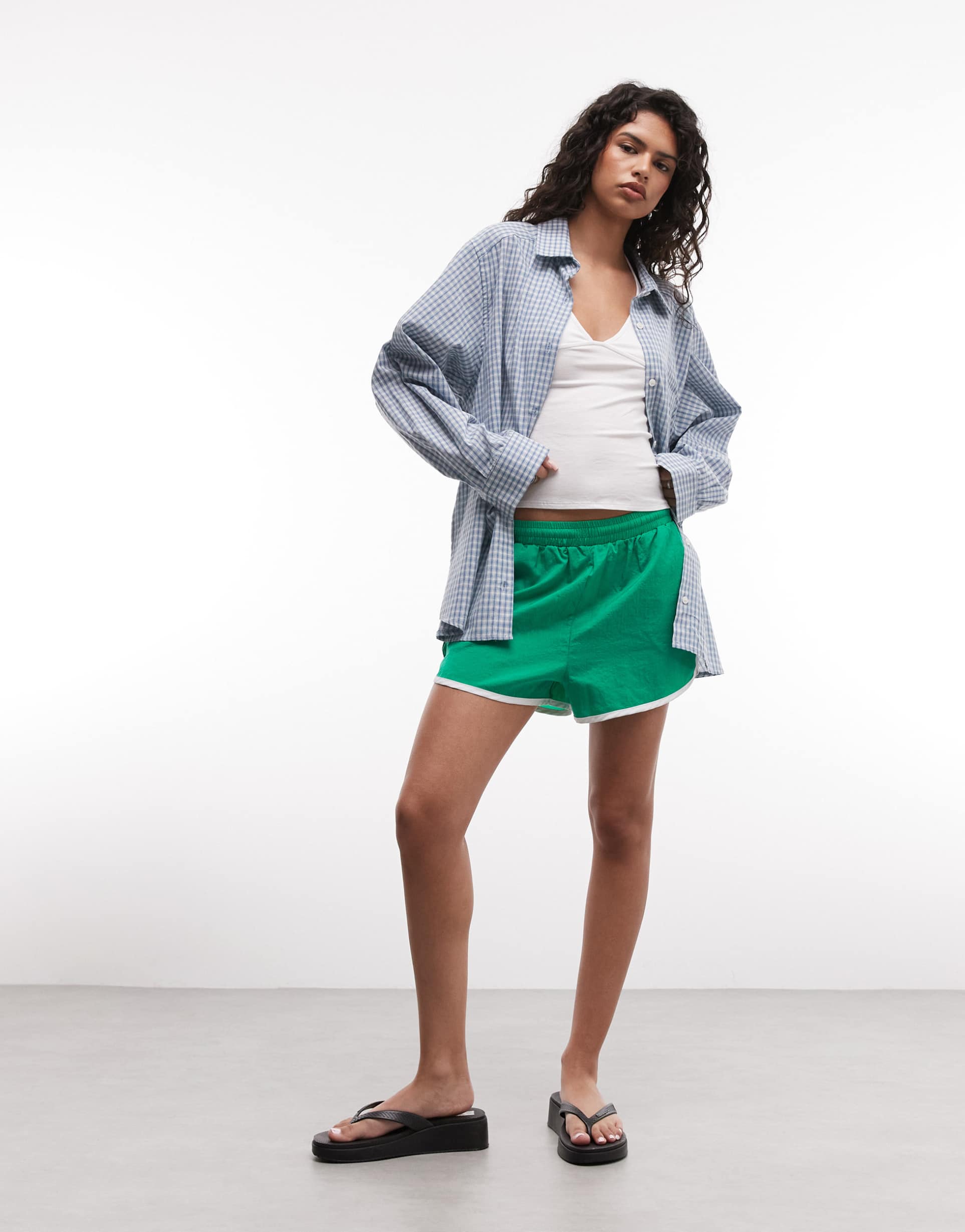 collusion dolphin hem runner shorts in green