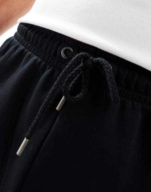 COLLUSION jersey shorts in black