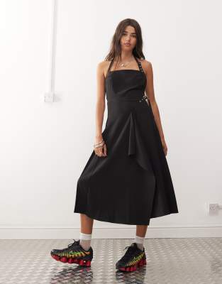 midi pinny dress with pleated hem and hardware detail in black