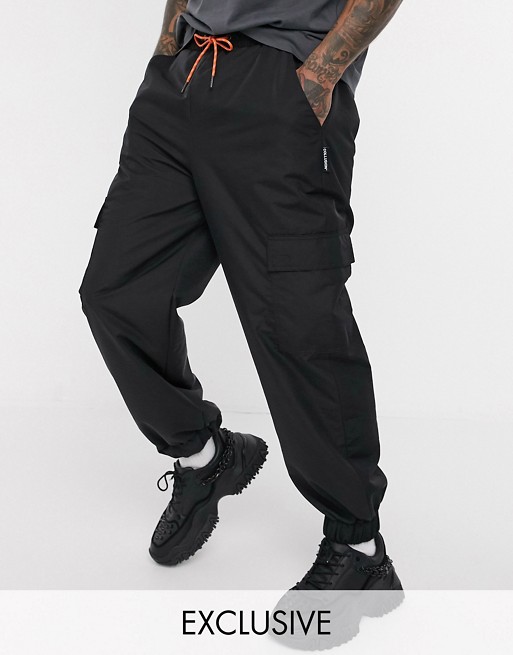 COLLUSION nylon cargo trousers with pockets in black