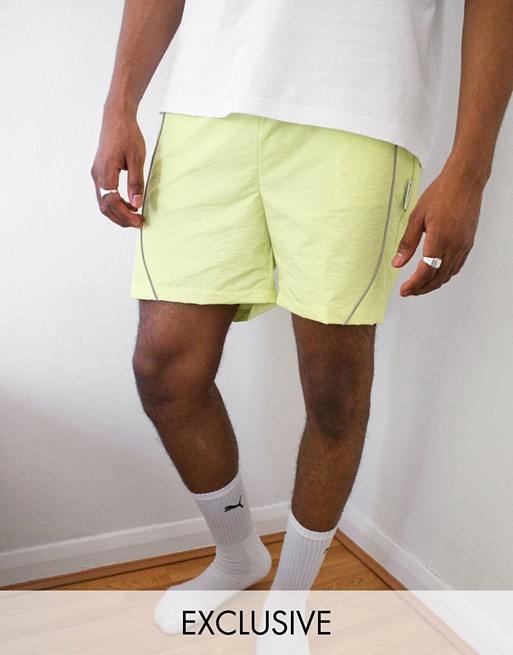 COLLUSION nylon shorts with reflective piping in acid lime