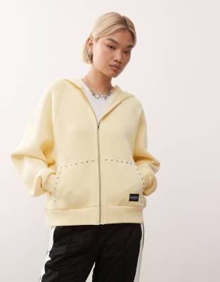 COLLUSION - Oversize-Kapuzenjacke in Buttermilchgelb mit Reißverschluss und Nieten-Details