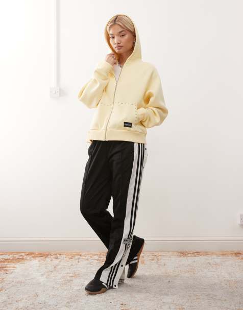 COLLUSION – Oversize-Kapuzenjacke in Buttermilchgelb mit Reißverschluss und Nieten-Details - view 1